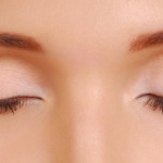 Сleaning woman face with cotton pads. Cosmetic treatment.