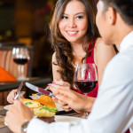 Chinese couple having romantic dinner in fancy restaurant