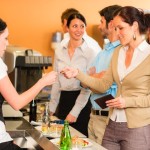 women paying bill