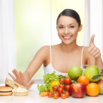 woman with fruits rejecting junk food