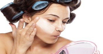 beautiful woman with curlers applied poorly chosen foundation