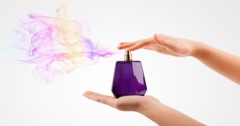 woman hands spraying perfume